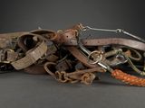 a pile of old leather and metal items on a table