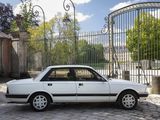 a white car that is parked in front of a gate