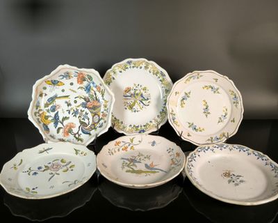 several plates are arranged on a black table with a black background