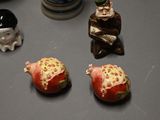 three figurines sitting on a table next to each other