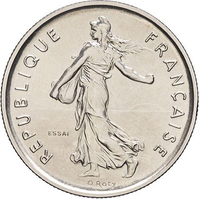 an image of a silver coin with a lady walking on it