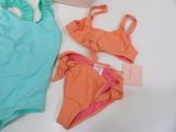 two swimsuits that are sitting on a table