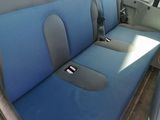 a blue seat cover in the back of a car