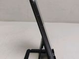 a cell phone that is sitting on top of a stand