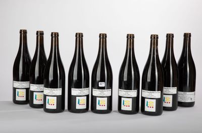 six bottles of wine lined up in a row on a table
