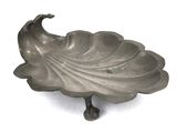 an image of a silver plate with a bird on top of it
