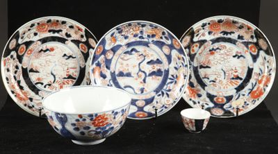 four pieces of japanese porcelain on a black background