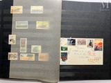 an open book with stamps on it on a table