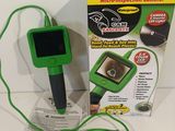 a green and black electronic device on a white table
