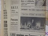 several old newspapers are stacked on top of each other on a table