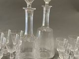 a lot of wine glasses and a decanter on the table