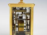 a gold clock that is sitting on top of a table