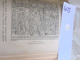 an open book with a piece of paper on top of it