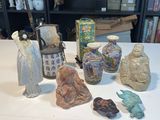 a table that has a lot of vases and statues on it