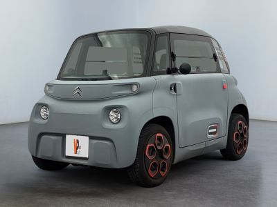 an image of a small electric car in a white room