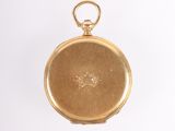 an old gold pocket watch with a chain hanging from it ' s side