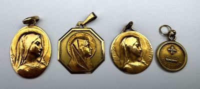 three gold medals of the virgin mary and jesus on a white background