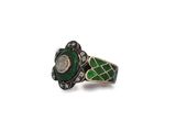 a close up of a ring with a green stone in it