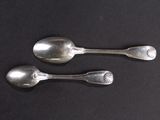 two spoons that are sitting on a table