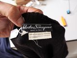 a person holding a label on a black sock