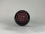 a close up of a wine bottle with a red label on it
