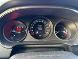 a close up of a car dashboard with gauges and speedometers