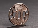 an image of a silver broochle with a flower and leaves on it