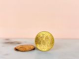 a gold coin sitting on top of a marble counter