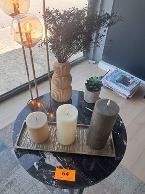 a table with candles and a tray with flowers on it