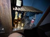 a bottle of beer sitting on a shelf next to a bottle of beer