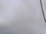 an image of a white purse on a white surface