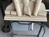 une statue représentant une femme assise sur un banc