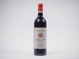 a bottle of red wine sitting on top of a white table