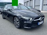 a black mercedes cla parked in front of a building