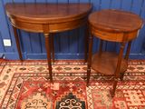 two small tables on a rug with a blue wall in the background