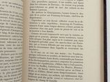 an open book on a white surface with a black border