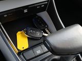 the interior of a car with a car key in the center console