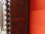 a tall wooden cabinet in the corner of a room