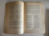 an open book on a table with a cup of coffee next to it