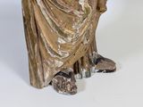 a statue of a man with a hat and a robe