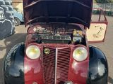 a red and black car that is parked in a parking lot