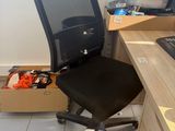 a desk with a chair and a computer on it