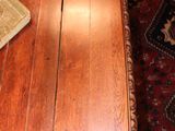 a wooden table with a book and a vase on it