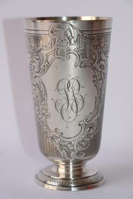 a silver cup that has a monogram on it