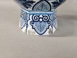 a blue and white bowl sitting on top of a table