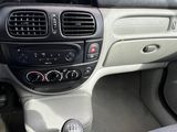 the interior of a car with a steering control and dashboard controls