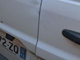 a white car that has a number plate on the side of it