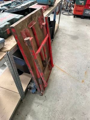 a pile of old tools on a table in a warehouse