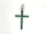 a close up of a cross with green stones on a white background