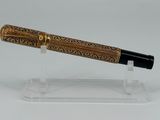 an image of a pen on a clear stand on a white surface